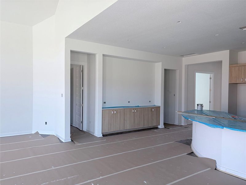 A well-lit interior showcases a new build's spacious layout with recessed lighting and neutral tones. A well-lit interior showcases a new build's spacious layout with recessed lighting and neutral tones.