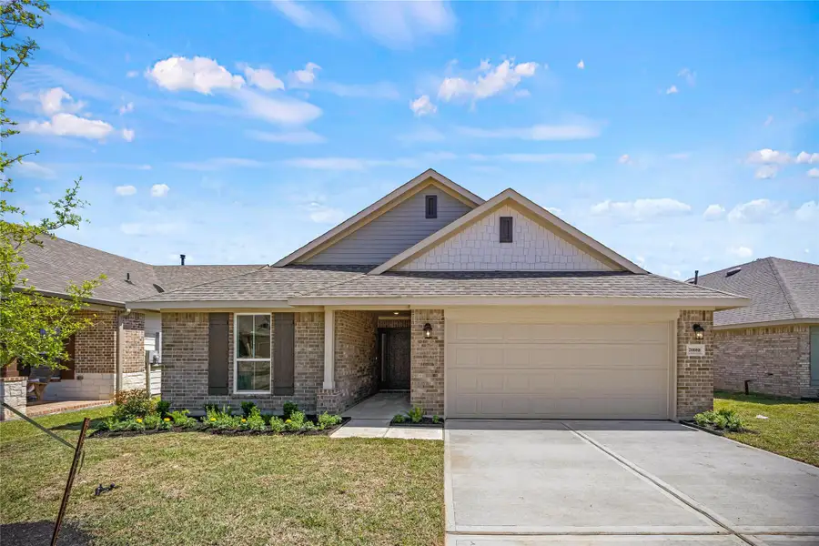 Front exterior of a new home in Grand Oaks Reserve, Cleveland, TX, highlighting curb appeal (Image 1).