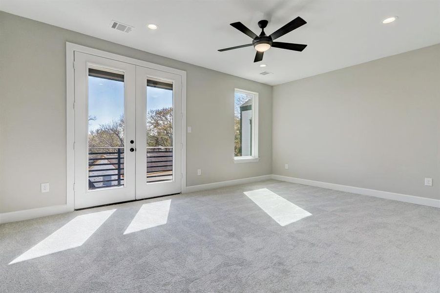 Spacious Primary Bedroom with french doors that lead to private balcony