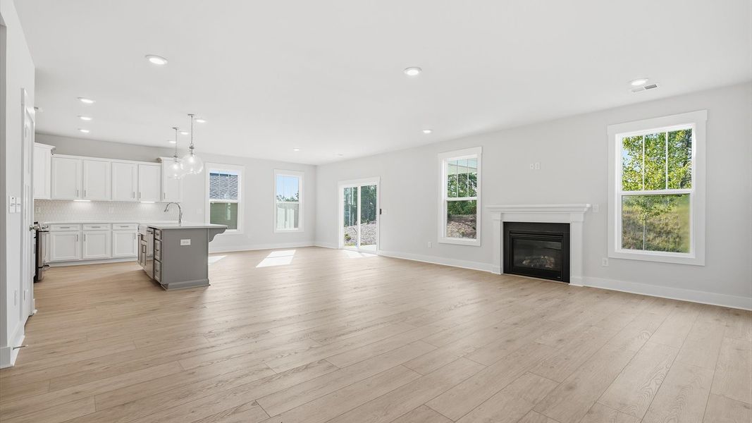 First-rate living space with tasteful hardwood floors and a functional open-concept design by DRB Homes