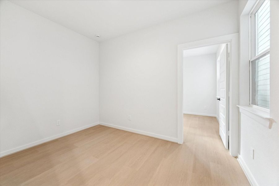 Shot of the guest suite shows a flexible space ideal for a workout room, study, game room, TV room, or cozy reading area. This versatile room flows directly into a private bedroom with an ensuite bath, offering comfort and convenience for guests or everyday use.