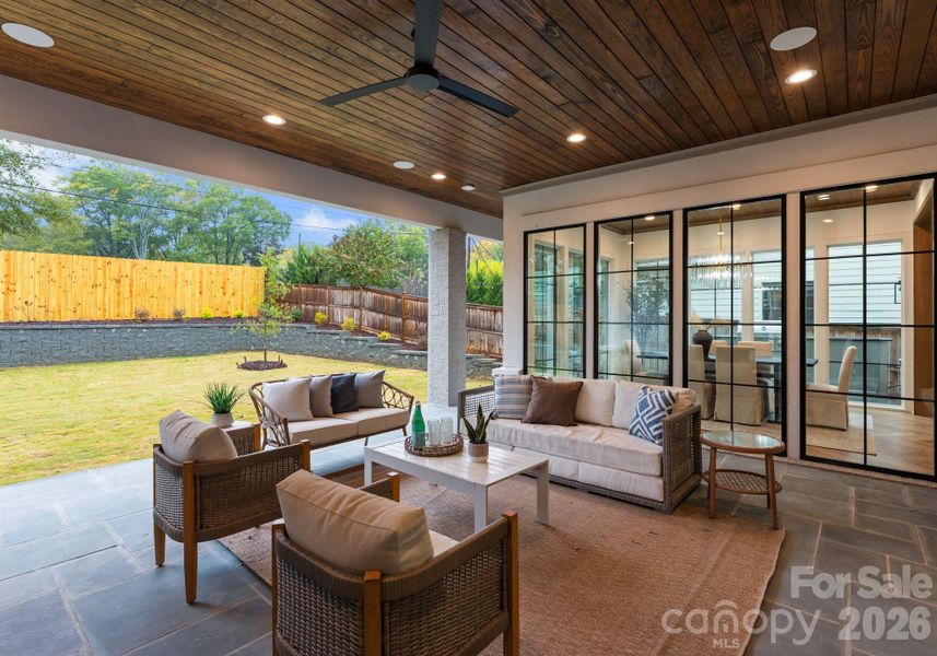 blue stone covered porch with built in speakers and a fireplace