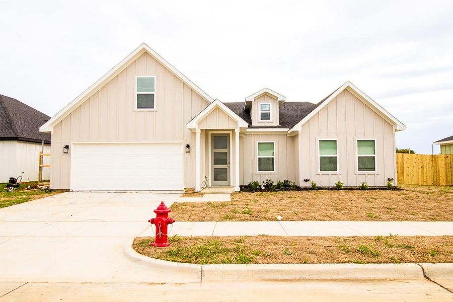 Front exterior of a new home in , Godley, TX, highlighting curb appeal (Image 1). Front exterior of a new home in , Godley, TX, highlighting curb appeal (Image 1).