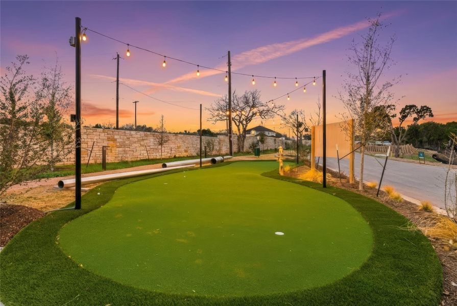 View of home's community with an area to practice putting