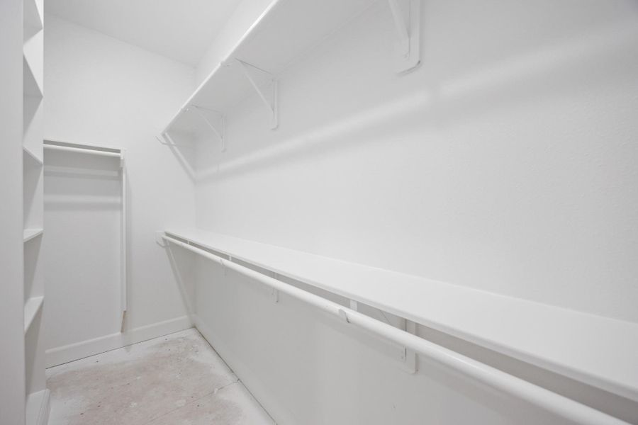 This is just one of two spacious walk-in closets in the primary suite—designed to keep your wardrobe beautifully organized and always within easy reach. This is just one of two spacious walk-in closets in the primary suite—designed to keep your wardrobe beautifully organized and always within easy reach.