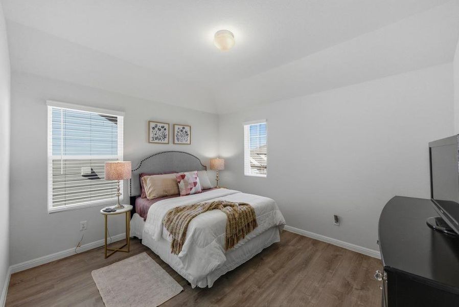 Bedroom featuring baseboards and wood finished floors