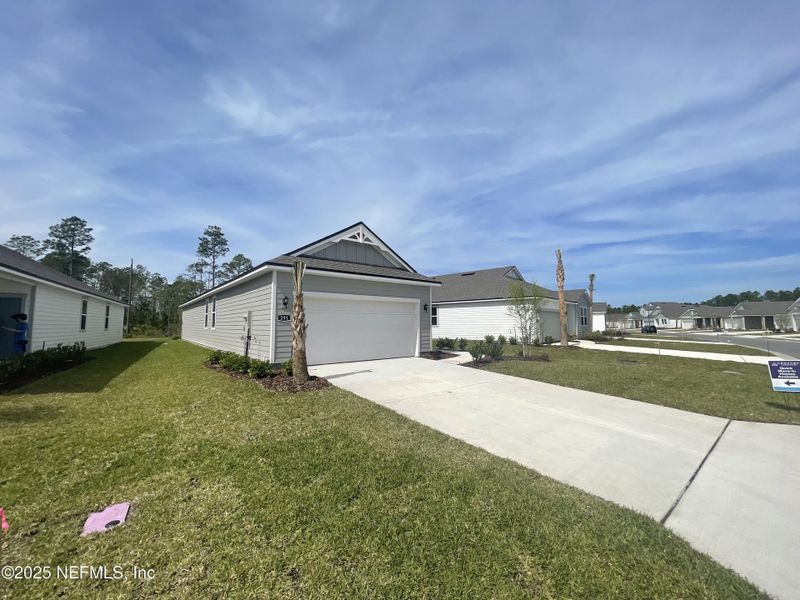 Front exterior of a new home in Palm Series at Seminole Palms, Palm Coast, FL, highlighting curb appeal (Image 21).