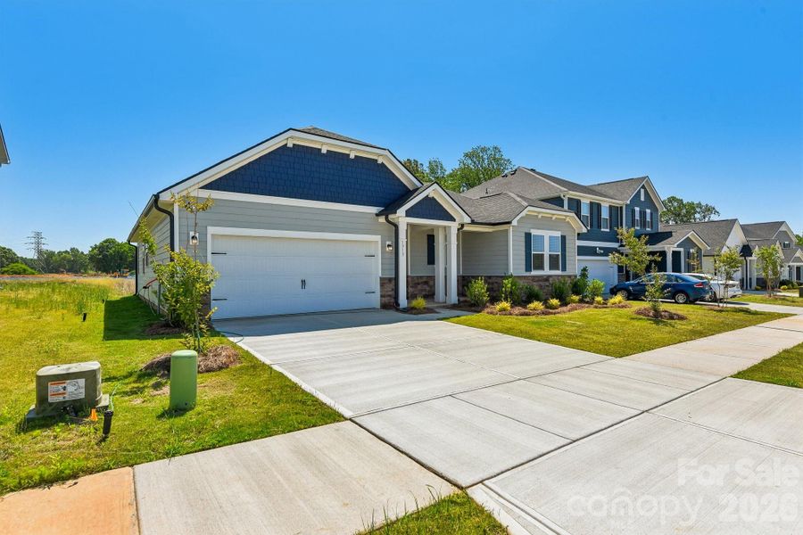 Front exterior of a new home in , Monroe, NC, highlighting curb appeal (Image 20).