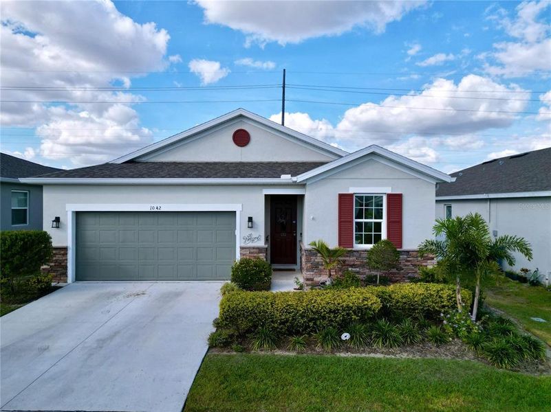 Front exterior of a new home in Seasons at Heritage Square, Haines City, FL, highlighting curb appeal (Image 23). Front exterior of a new home in Seasons at Heritage Square, Haines City, FL, highlighting curb appeal (Image 23).