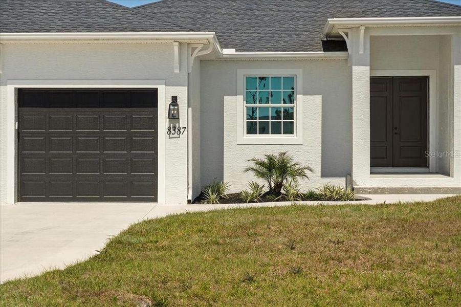 Front exterior of a new home in , Port Charlotte, FL, highlighting curb appeal (Image 21).