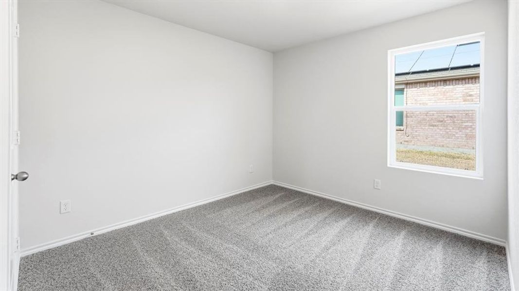 Carpeted spare room featuring baseboards Carpeted spare room featuring baseboards