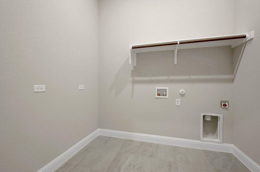 Washroom with hookup for a gas dryer, washer hookup, and hookup for an electric dryer