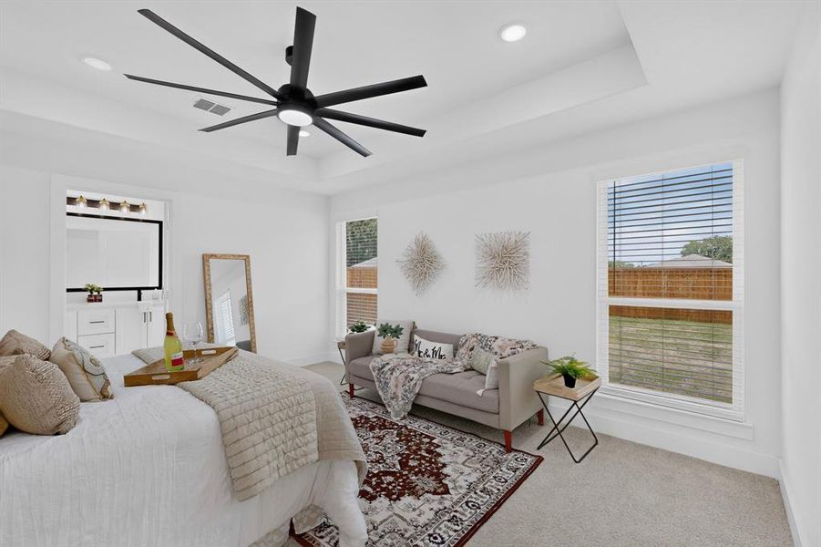 Spacious room with a ceiling fan, recessed lighting, and a tray ceiling