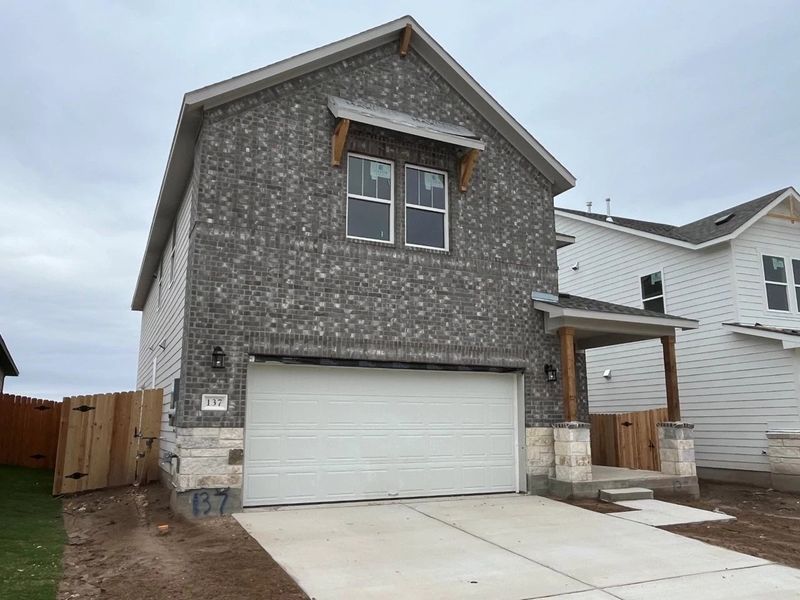 Front exterior of a new home in Lariat, Liberty Hill, TX, highlighting curb appeal (Image 4).