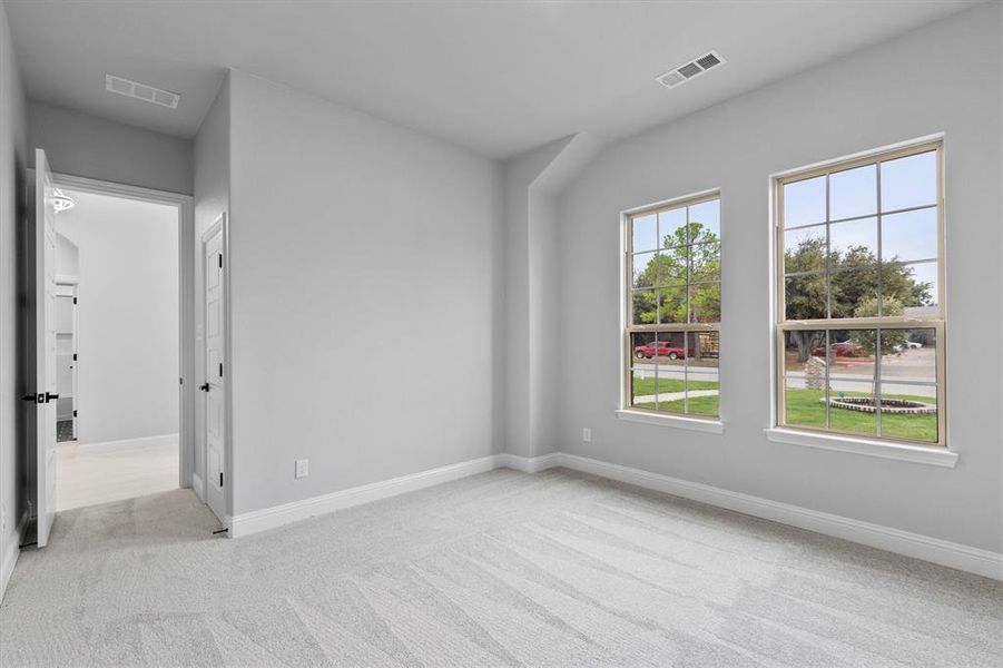 Empty room with light colored carpet