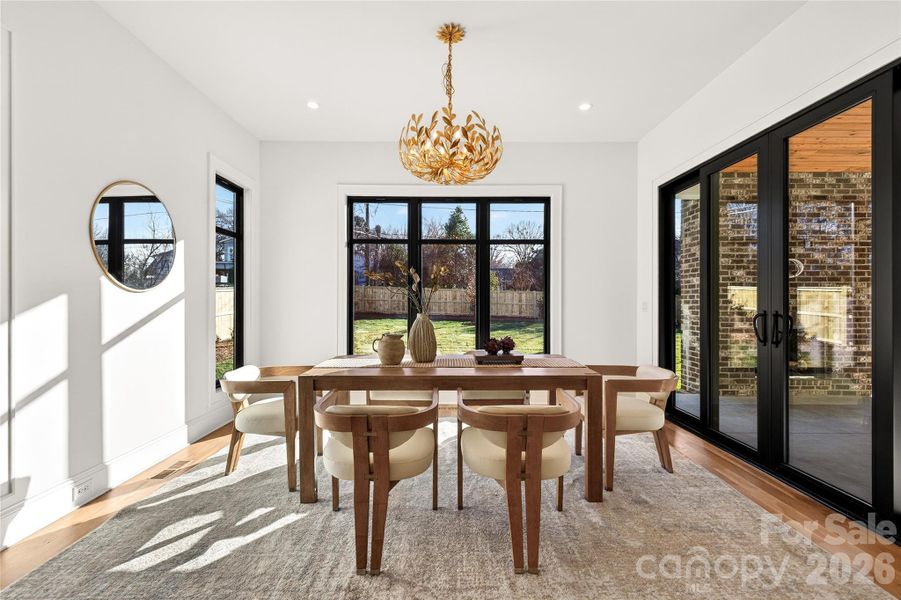Dining Room on the rear of the home off of the Kitchen. Overlooks the level back yard and the rear Porch. Beautiful lighting.