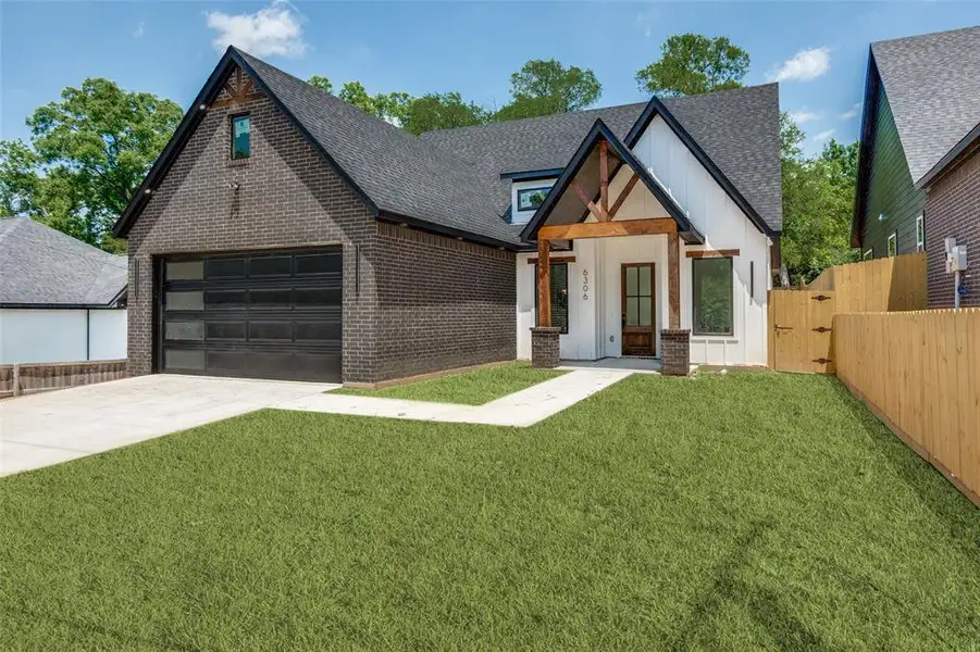 Modern farmhouse architecture featuring dark brick and white vertical siding Modern farmhouse architecture featuring dark brick and white vertical siding