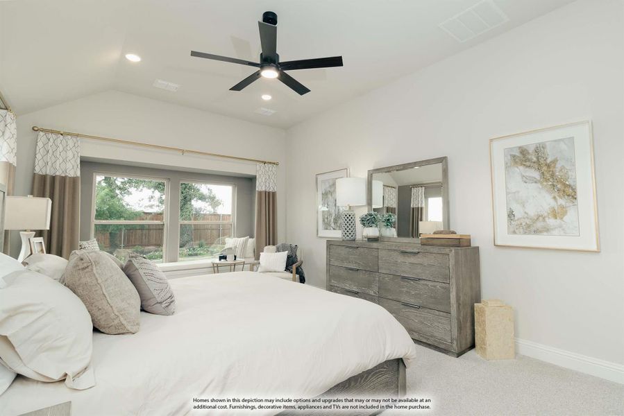 Bedroom with vaulted ceiling, black ceiling fan, gray wood dresser, and large window with backyard view
