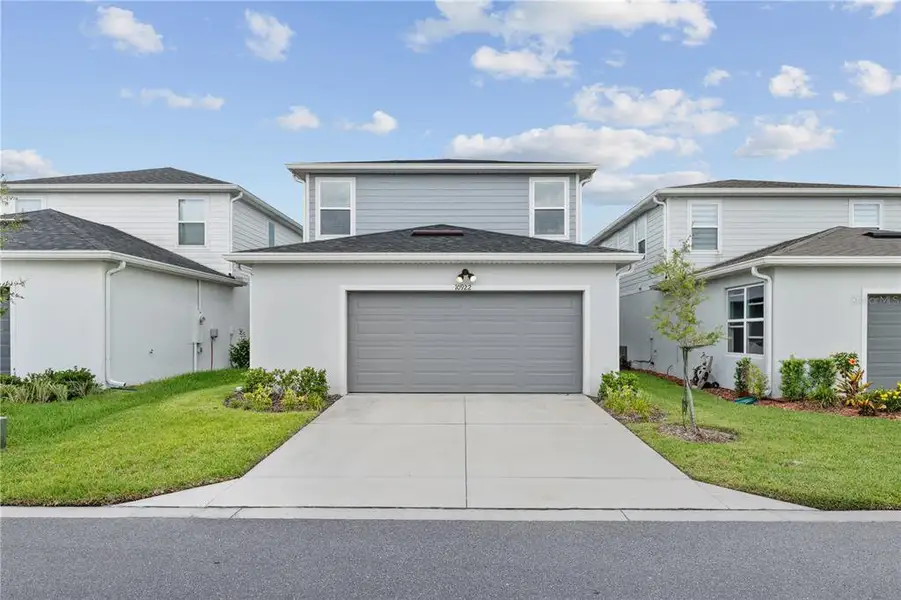 Front exterior of a new home in EverBe, Orlando, FL, highlighting curb appeal (Image 20).