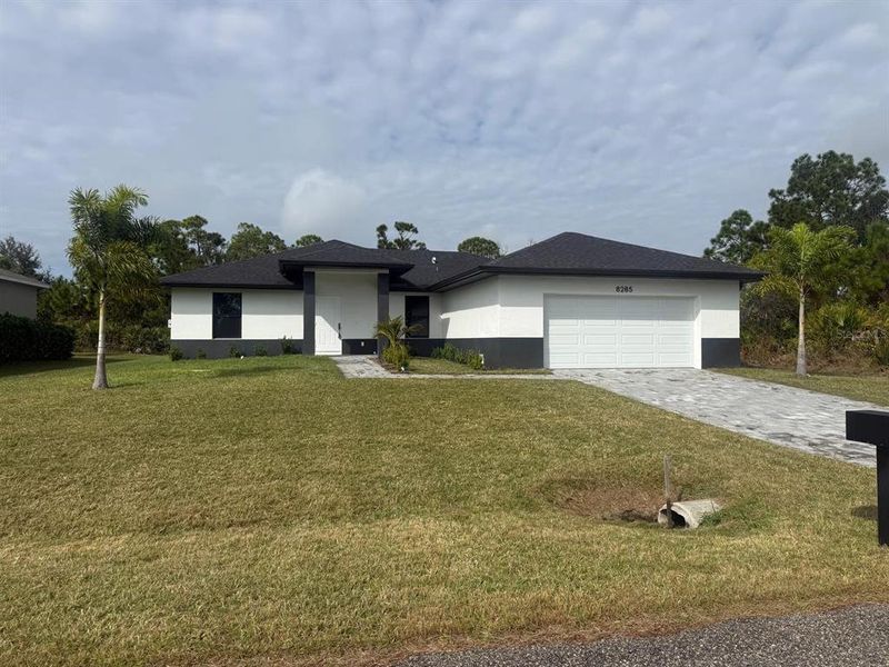 Front exterior of a new home in , Port Charlotte, FL, highlighting curb appeal (Image 9).