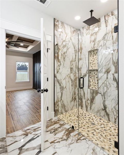 Bathroom with coffered ceiling, beam ceiling, and a shower with shower door