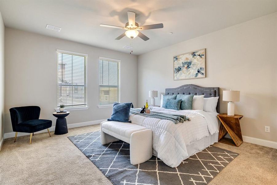 Bedroom featuring ceiling fan and carpet flooring