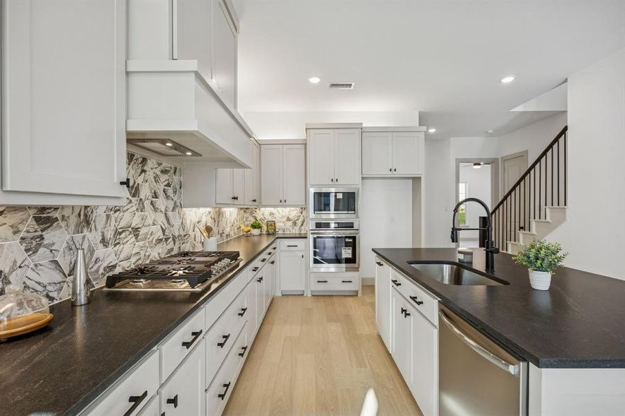 Your new chef's dream kitchen is classically styled in a striking black and white color palette.