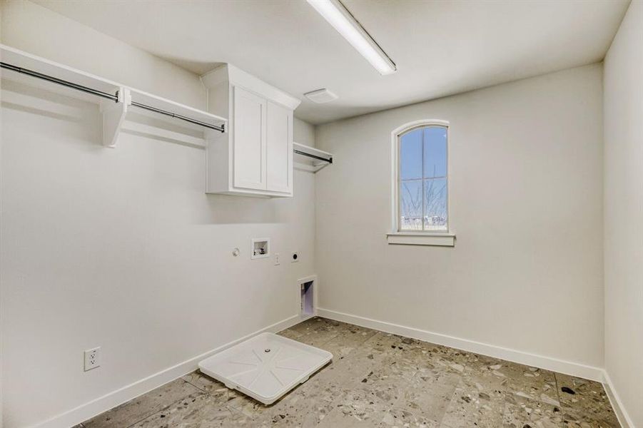 Laundry room featuring hookup for a gas dryer, hookup for an electric dryer, hookup for a washing machine, and cabinet space