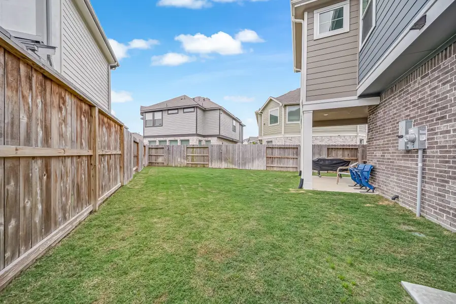 Exterior details and patio area of a home in The Groves, Humble (Image 4).