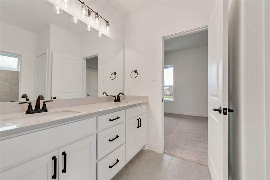 Bathroom featuring tile patterned flooring and vanity