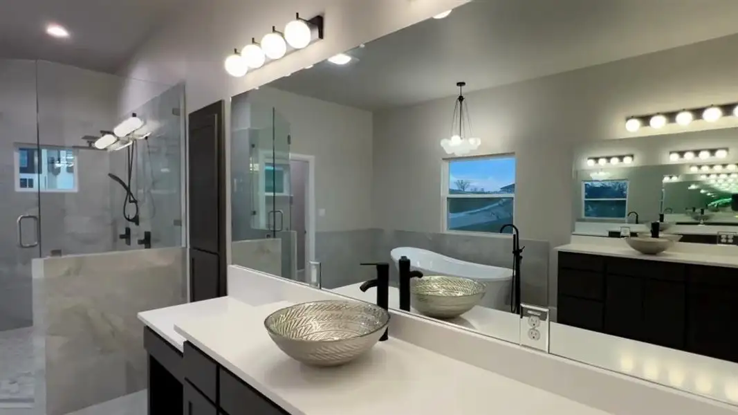Full bathroom with a stall shower, vanity, and a soaking tub