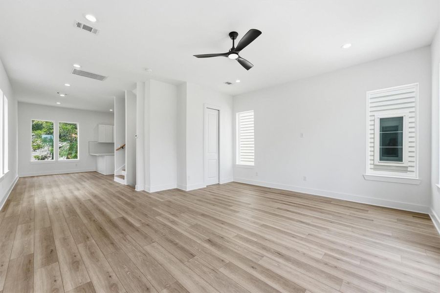 This is the space where life happens. A wide-open living and dining area with soaring ceilings, recessed lighting, and rich LVP flooring gives you room to gather, entertain, and truly spread out. This is the space where life happens. A wide-open living and dining area with soaring ceilings, recessed lighting, and rich LVP flooring gives you room to gather, entertain, and truly spread out.