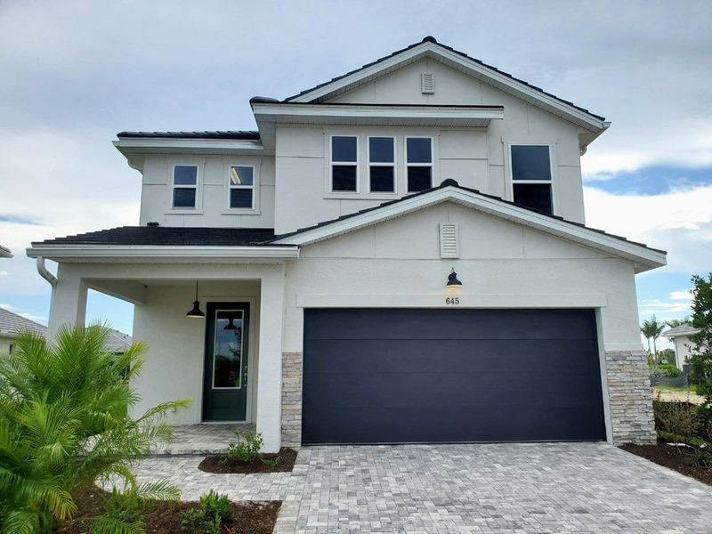 Representative exterior photo of a completed home built from the The Lennox by David Weekley Homes in Vistera of Venice – Garden Series, Nokomis, FL (Image 1). Representative exterior photo of a completed home built from the The Lennox by David Weekley Homes in Vistera of Venice – Garden Series, Nokomis, FL (Image 1).
