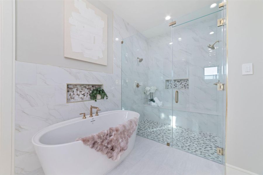 Freestanding soaking tub with luxury finishes and bright natural light.