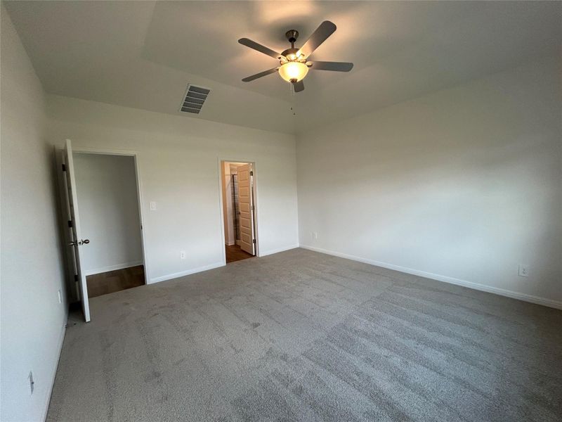 Unfurnished bedroom featuring carpet and ceiling fan Unfurnished bedroom featuring carpet and ceiling fan