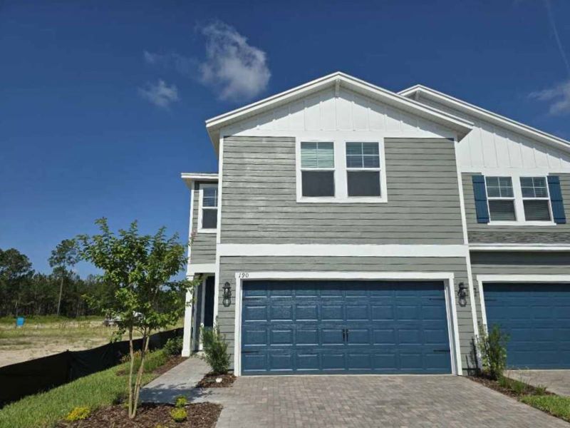Front exterior of a new home in Parkside at Shearwater, St. Johns, FL, highlighting curb appeal (Image 1). Front exterior of a new home in Parkside at Shearwater, St. Johns, FL, highlighting curb appeal (Image 1).