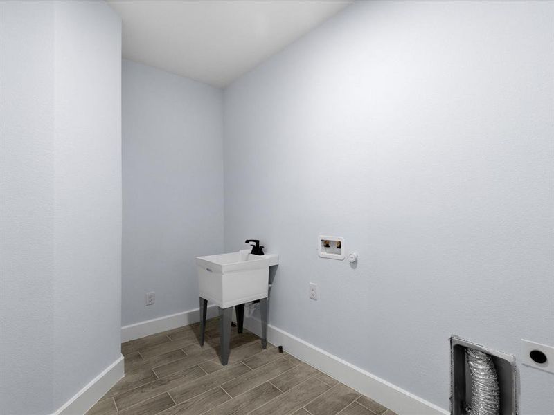 Laundry area featuring washer hookup, wood tiled floors, and hookup for an electric dryer