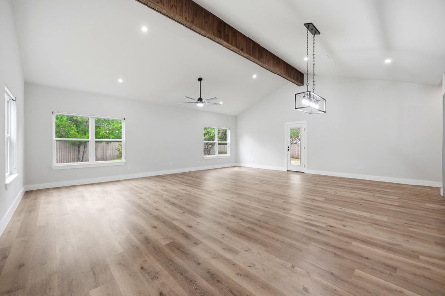 An airy living space features soaring vaulted ceilings and rich wood flooring. An airy living space features soaring vaulted ceilings and rich wood flooring.