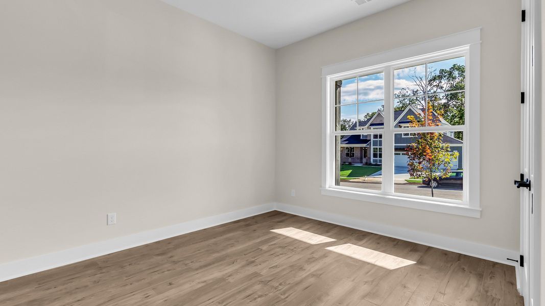 Secondary Bedroom with wood flooring (Representative of completed home)