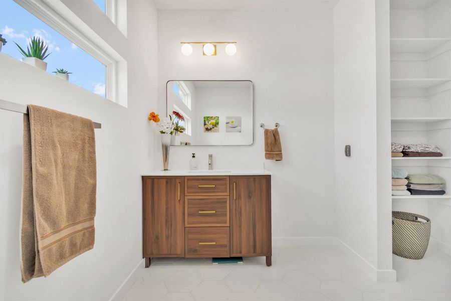 Bathroom featuring light tile patterned flooring and vanity