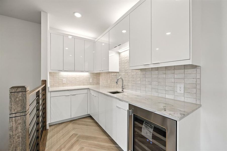 A wet bar located just off the game room creates an additional entertainment area. A wet bar located just off the game room creates an additional entertainment area.