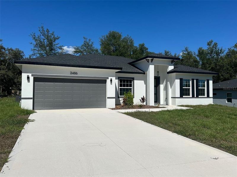 Front exterior of a new home in , Citrus Springs, FL, highlighting curb appeal (Image 1).