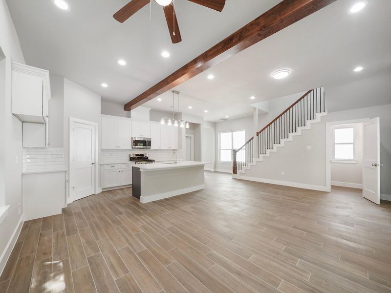 Kitchen is mix of navy blue island and white cabinets
