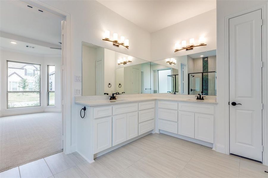 Separate vanities with quartz countertop.