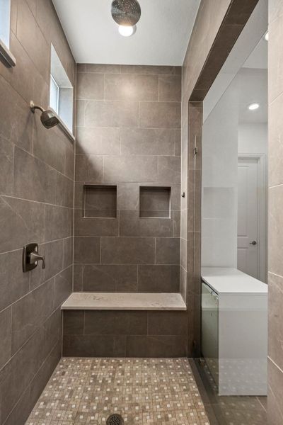 Bathroom featuring a tile shower