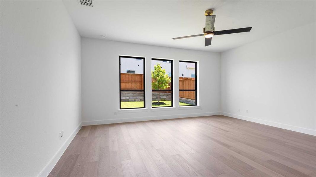 Unfurnished room with wood finished floors and a ceiling fan