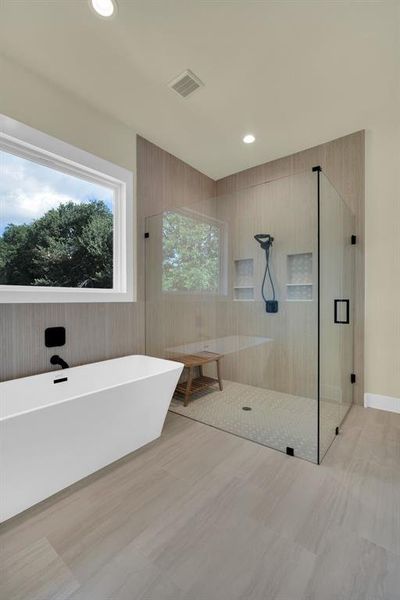 Bathroom featuring tile patterned flooring and independent shower and bath