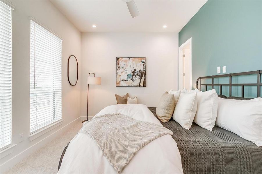 Step into the oversized primary suite, bathed in soft LED lighting that accentuates its spaciousness and elegance. This tranquil retreat offers a harmonious blend of comfort and style, providing a serene environment for rest and relaxation.