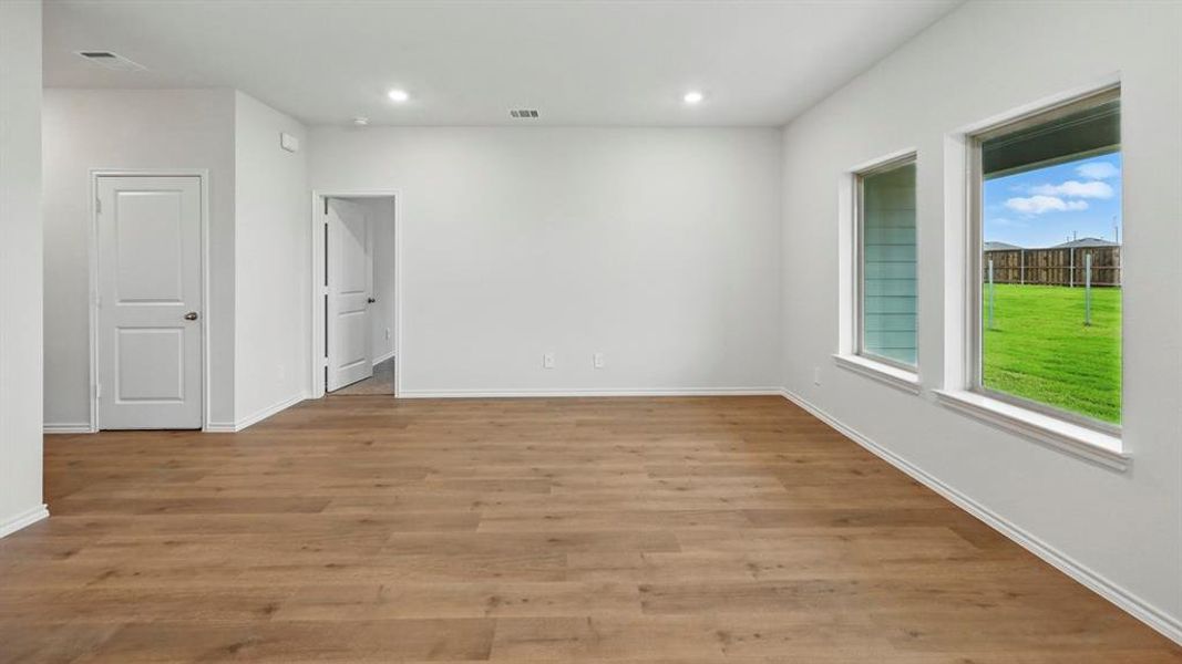Empty room featuring light wood-style flooring and recessed lighting