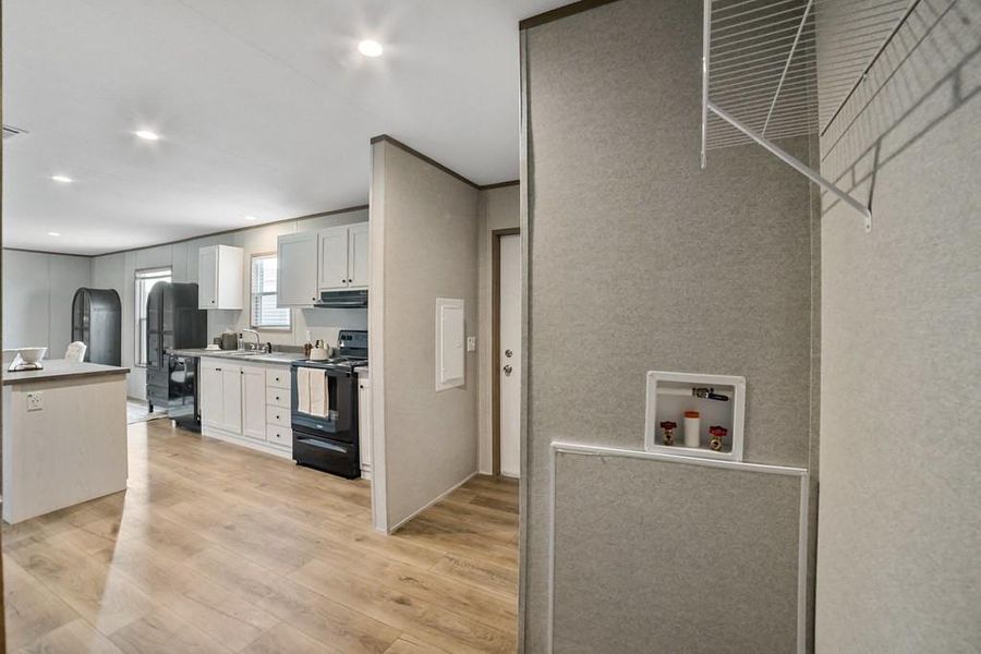 Kitchen featuring black appliances, white cabinets, and recessed lighting Kitchen featuring black appliances, white cabinets, and recessed lighting